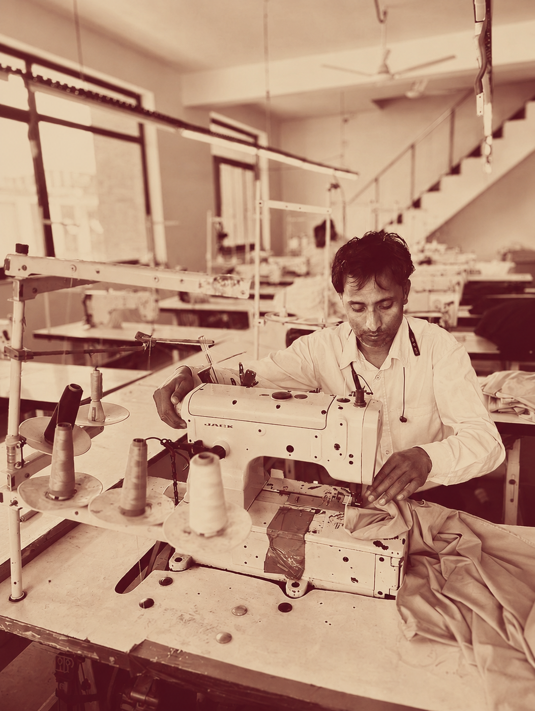 The Auraa atelier — tailor at work on a hospitality uniform